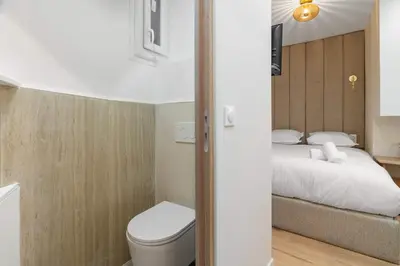 Un ou plusieurs lits dans un hébergement de l'établissement Charmante suite paris 17E