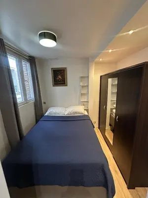 Un ou plusieurs lits dans un hébergement de l'établissement Modern Studio Apartment Champs Élysées Stars