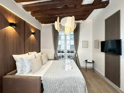Un ou plusieurs lits dans un hébergement de l'établissement Notre-Dame - Deluxe studio for 4