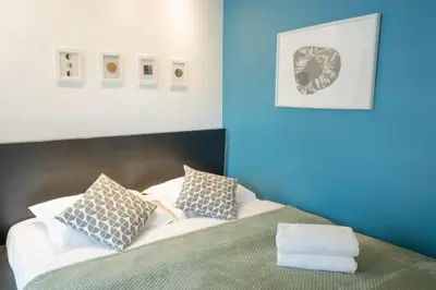 Un ou plusieurs lits dans un hébergement de l'établissement Grand studio loft bien equipe a Paris 15 - 2P
