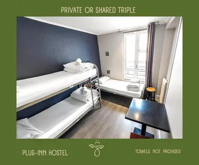 Un ou plusieurs lits dans un hébergement de l'établissement Plug inn Montmartre by Hiphophostels