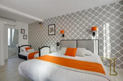 Un ou plusieurs lits dans un hébergement de l'établissement Hotel Riviera Elysees