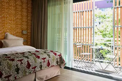 Un ou plusieurs lits dans un hébergement de l'établissement Eden Lodge Paris