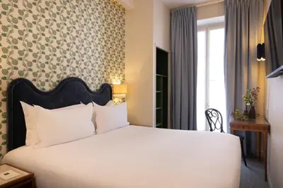 Un ou plusieurs lits dans un hébergement de l'établissement Hotel Michelet Odeon