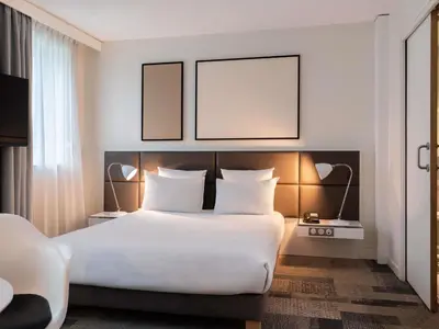Un ou plusieurs lits dans un hébergement de l'établissement Novotel Suites Paris Expo Porte de Versailles