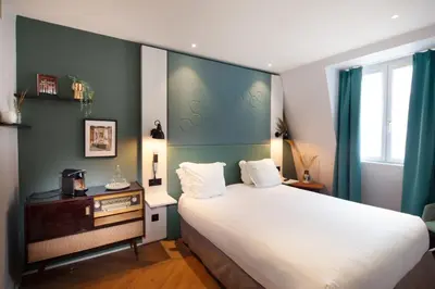 Un ou plusieurs lits dans un hébergement de l'établissement Hôtel Vendome Saint-Germain