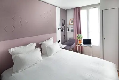 Un ou plusieurs lits dans un hébergement de l'établissement Hôtel Vendome Saint-Germain