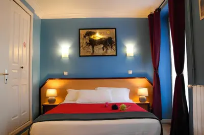 Un ou plusieurs lits dans un hébergement de l'établissement Hotel Audran
