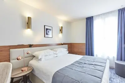 Un ou plusieurs lits dans un hébergement de l'établissement Hotel Royal Phare