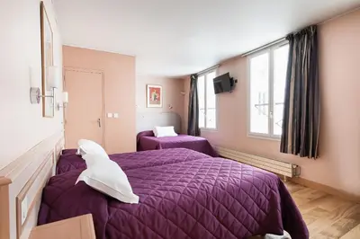 Un ou plusieurs lits dans un hébergement de l'établissement Hotel Americain