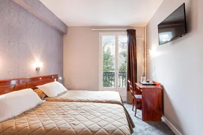 Un ou plusieurs lits dans un hébergement de l'établissement Hotel Americain