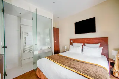 Un ou plusieurs lits dans un hébergement de l'établissement Queens Boutique Hotel