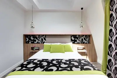 Un ou plusieurs lits dans un hébergement de l'établissement Hotel Alhambra
