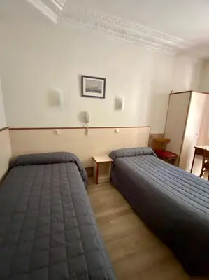 Un ou plusieurs lits dans un hébergement de l'établissement Hotel Studia
