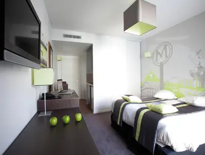 Un ou plusieurs lits dans un hébergement de l'établissement Lagrange Apart’Hotel Paris-Boulogne