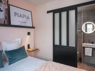 Un ou plusieurs lits dans un hébergement de l'établissement Hôtel Piapia
