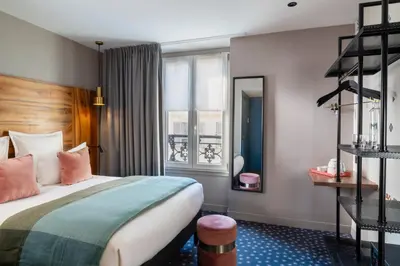 Un ou plusieurs lits dans un hébergement de l'établissement Hôtel Maxim Folies