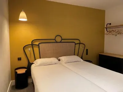 Un ou plusieurs lits dans un hébergement de l'établissement Hotel De Suez