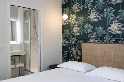 Un ou plusieurs lits dans un hébergement de l'établissement Hotel De Suez