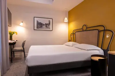 Un ou plusieurs lits dans un hébergement de l'établissement Hotel De Suez