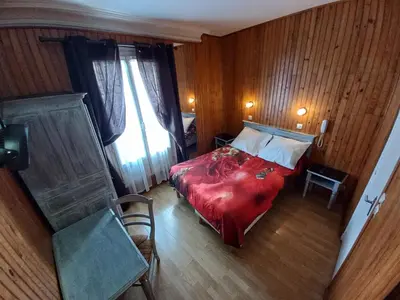 Un ou plusieurs lits dans un hébergement de l'établissement Hôtel Paris Nord