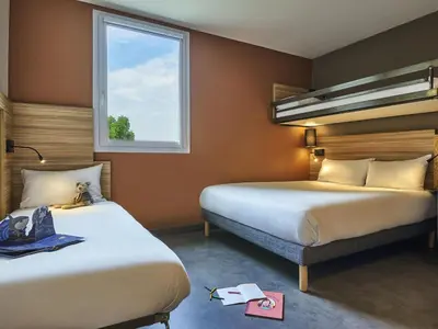 Un ou plusieurs lits dans un hébergement de l'établissement Greet Hotel Paris porte de la Chapelle - Aréna