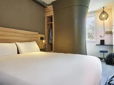 Un ou plusieurs lits dans un hébergement de l'établissement Greet Hotel Paris porte de la Chapelle - Aréna