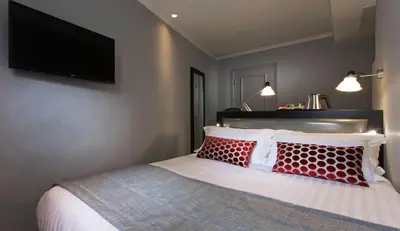 Un ou plusieurs lits dans un hébergement de l'établissement Hôtel Garance