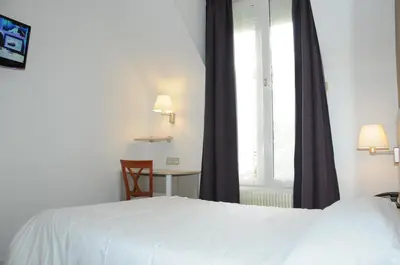 Un ou plusieurs lits dans un hébergement de l'établissement Hôtel Patio Brancion