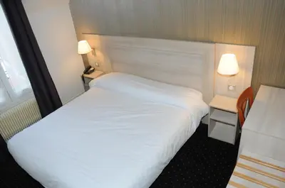 Un ou plusieurs lits dans un hébergement de l'établissement Hôtel Patio Brancion