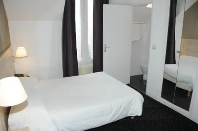 Un ou plusieurs lits dans un hébergement de l'établissement Hôtel Patio Brancion