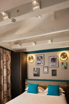 Un ou plusieurs lits dans un hébergement de l'établissement Hôtel Saint Germain