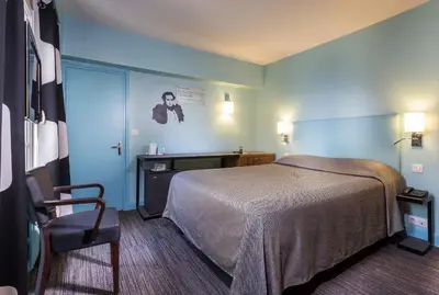 Un ou plusieurs lits dans un hébergement de l'établissement Hotel Concortel Paris