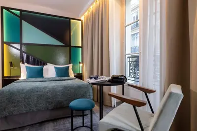 Un ou plusieurs lits dans un hébergement de l'établissement Le 12 Hôtel