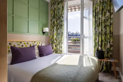 Un ou plusieurs lits dans un hébergement de l'établissement Hotel Clément