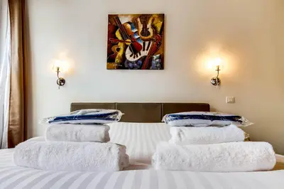 Un ou plusieurs lits dans un hébergement de l'établissement Upper Class Suites - Rue Saint Honoré