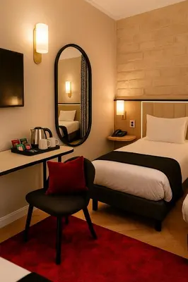 Un ou plusieurs lits dans un hébergement de l'établissement Grand Tonic hôtel & SPA Paris