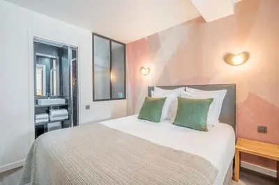 Un ou plusieurs lits dans un hébergement de l'établissement Yuna Les Halles - Serviced Apartments