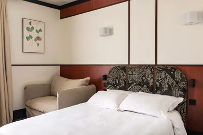 Un ou plusieurs lits dans un hébergement de l'établissement Hôtel Marguerite