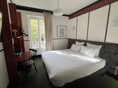 Un ou plusieurs lits dans un hébergement de l'établissement Hôtel Marguerite