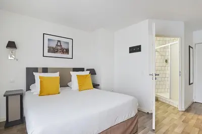 Un ou plusieurs lits dans un hébergement de l'établissement Appart'hôtel Odalys City - Paris Levallois