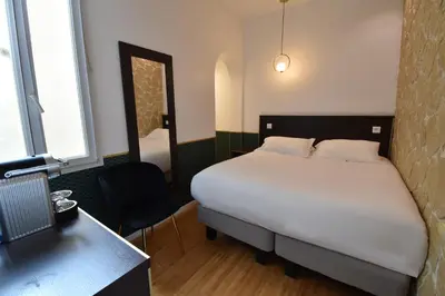 Un ou plusieurs lits dans un hébergement de l'établissement Hôtel Bonne Nouvelle