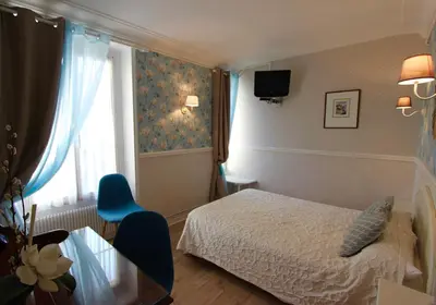 Un ou plusieurs lits dans un hébergement de l'établissement Hôtel Chopin