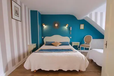Un ou plusieurs lits dans un hébergement de l'établissement Hôtel Chopin