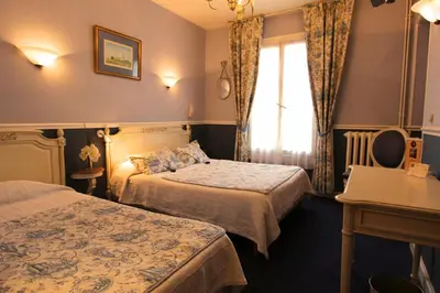Un ou plusieurs lits dans un hébergement de l'établissement Hôtel Chopin