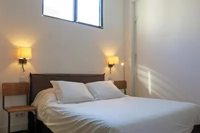 Un ou plusieurs lits dans un hébergement de l'établissement Loft Vinaigriers République