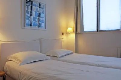 Un ou plusieurs lits dans un hébergement de l'établissement Loft Vinaigriers République