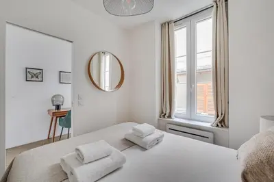 Un ou plusieurs lits dans un hébergement de l'établissement Residence Tour Eiffel by Studio prestige