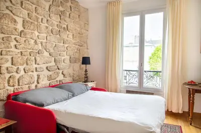 Un ou plusieurs lits dans un hébergement de l'établissement Studio Saint Louis en Ile