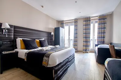 Un ou plusieurs lits dans un hébergement de l'établissement Hotel Migny Opéra Montmartre